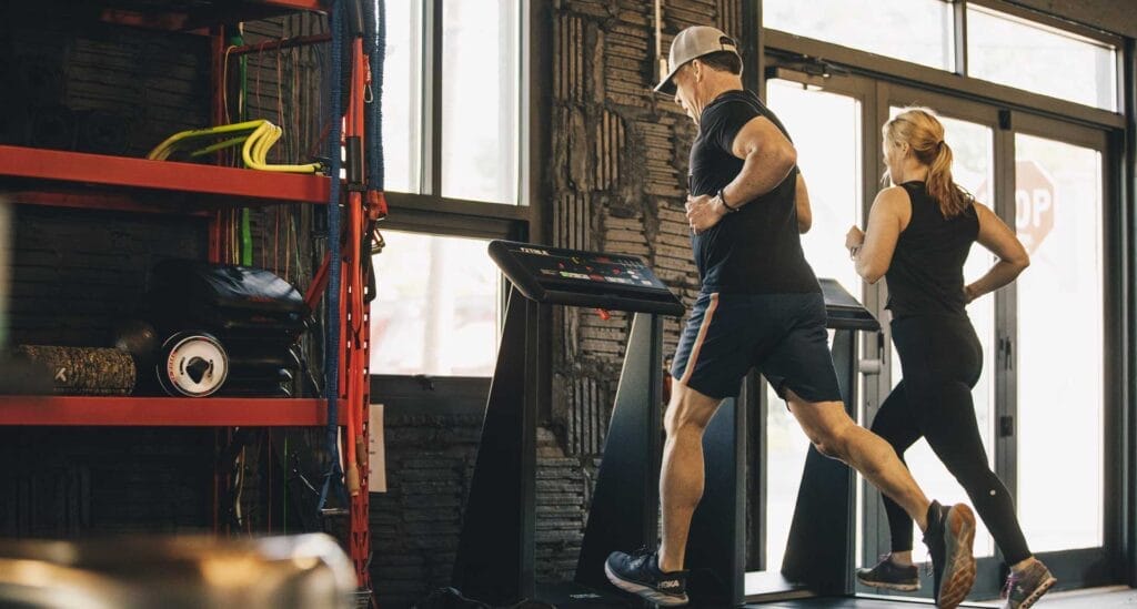 Man and woman running on small group personal training